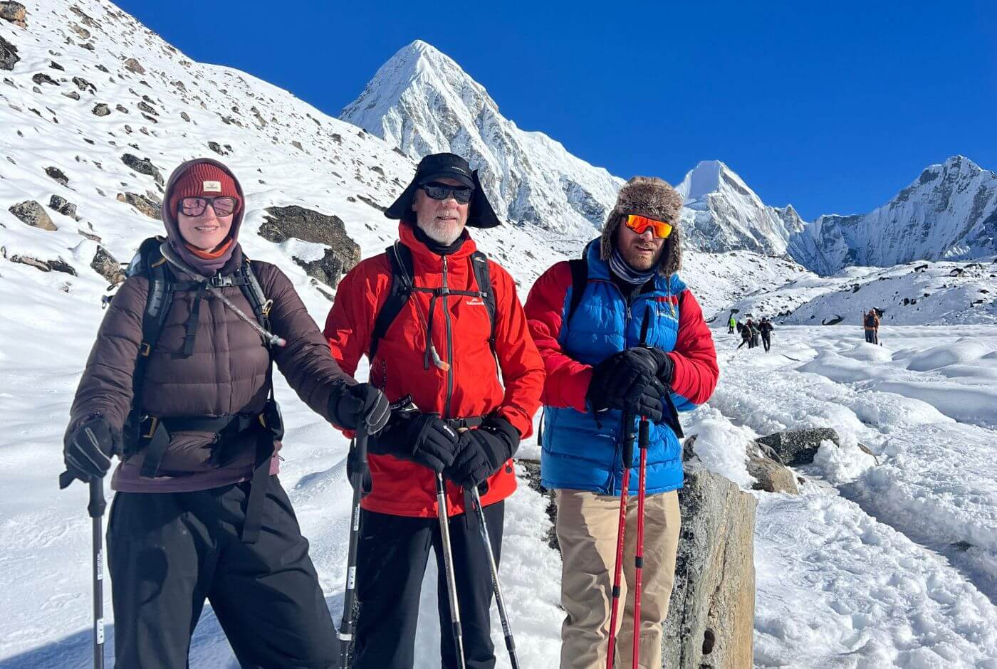 Trekkers walking from Gorak Shep toward Everest Base Camp with Mount Pumori visible along the Everest Base Camp trek route.