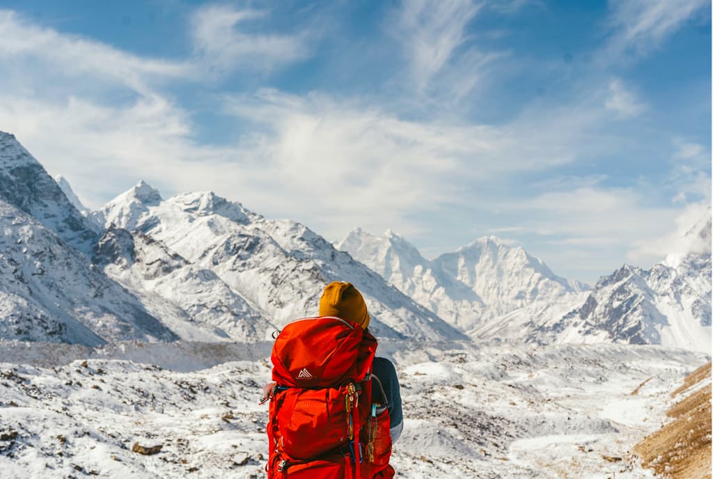 Hiker-woverlooking-snow-covered-Mountain-Peaks-of-Everest-Region.jpg
