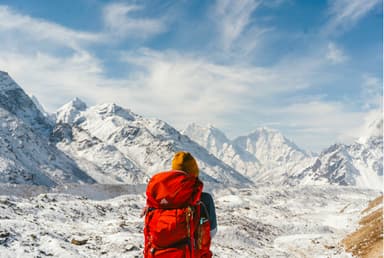 Hiker-woverlooking-snow-covered-Mountain-Peaks-of-Everest-Region.jpg