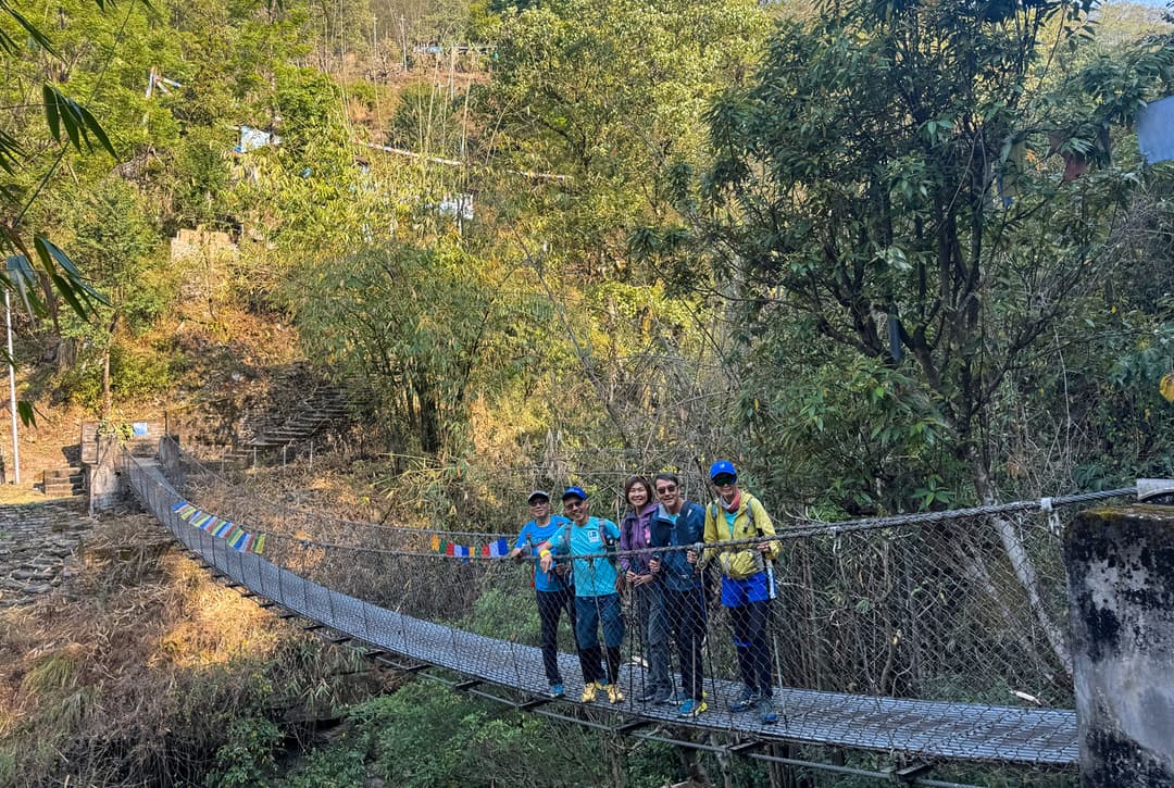 Trekkers climbing stone staircase from Tikhedhunga to Ulleri on Annapurna Sanctuary Trek