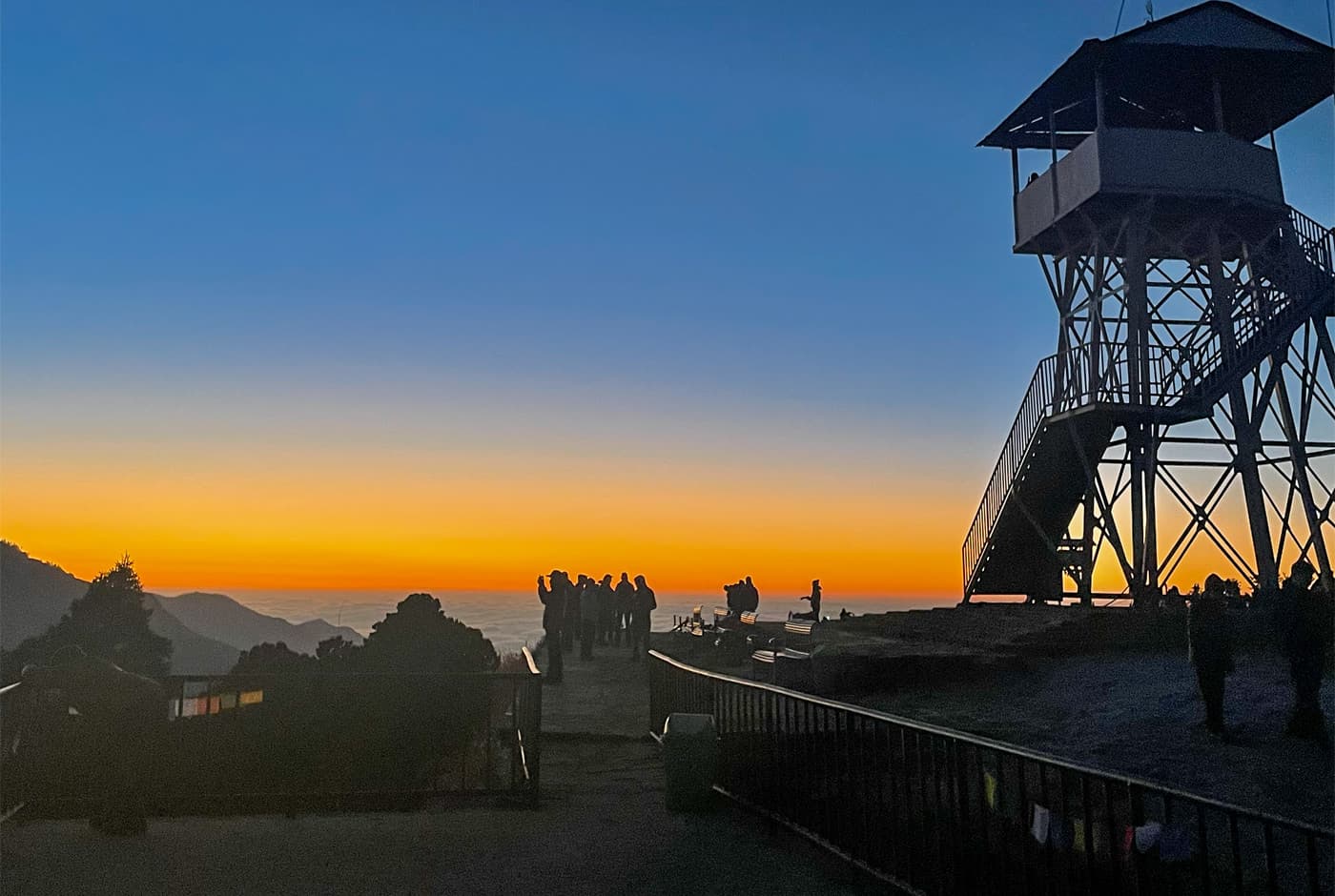 Poon Hill Observation Tower Silhouetted Against Colorful Dawn Sky With Trekkers On Viewing Platform, Annapurna Conservation Area