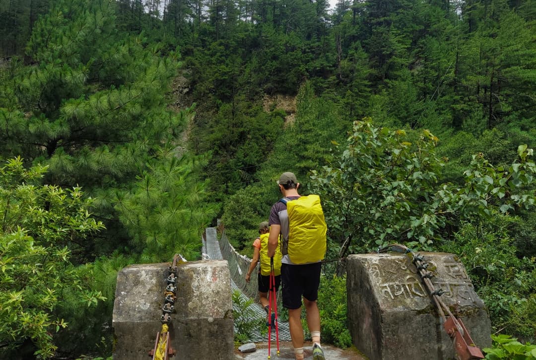 Suspension bridges near Dharapani or on the way from Jagat, surrounded by lush greenery typical of the lower Annapurna Circuit