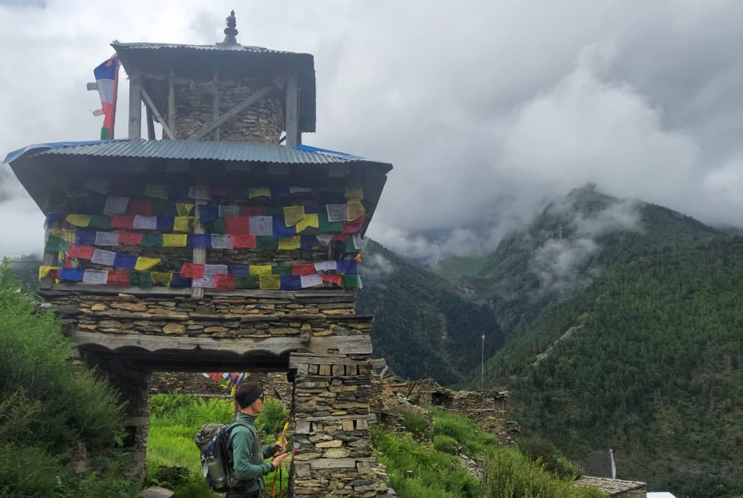Traditional village gateway in Upper Pisang, marked by prayer flags and stone construction