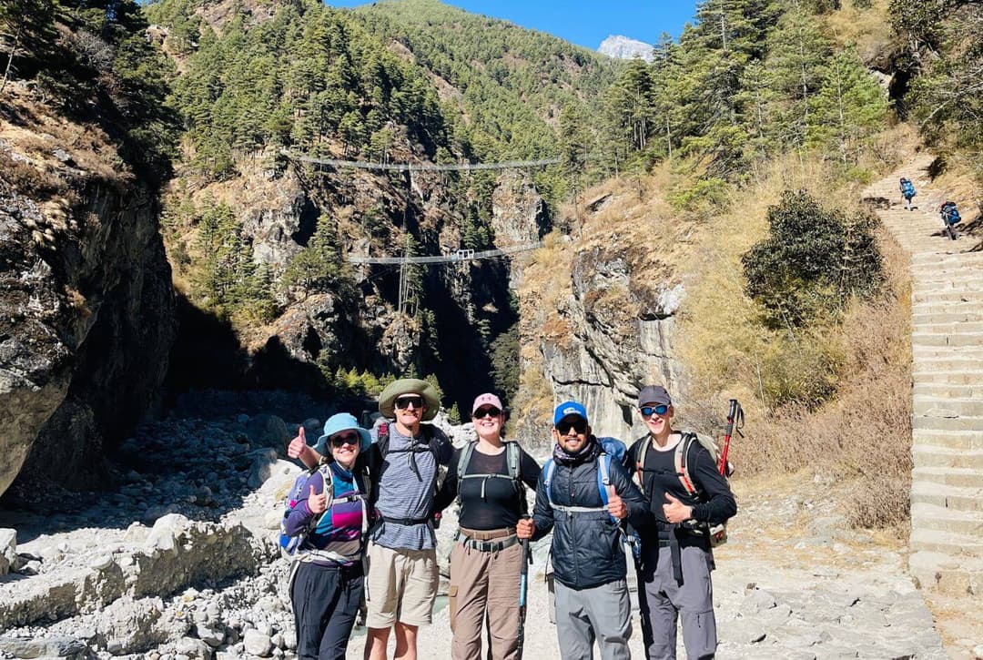 Group of trekkers standing on the trail during the final descent of the Everest Base Camp trek.